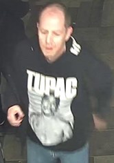 White man, balding, wearing a dark coloured sweatshirt