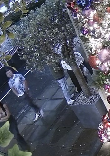 CCTV image showing white male in blue patterned t shirt