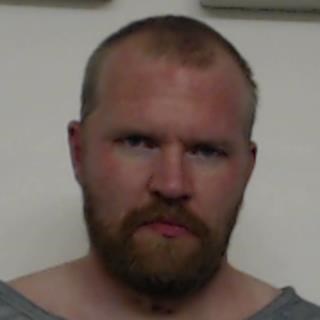 Aren Pearson, a white male with short receding hair, a beard and a grey t-shirt