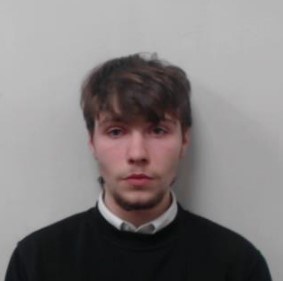 19-year-old white man with short, brown hair. Wearing a white shirt and black top