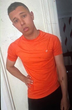 Image appeal for assault Saltmarket place mid 20s orange top and black trousers, black hair