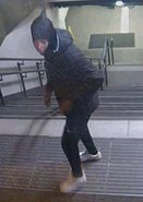 CCTV image of male in black jacket with hood