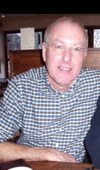 Man wearing checked shirt sitting in a bar