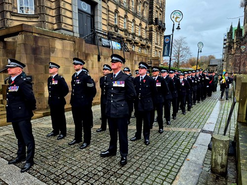 Police Scotland officers stand together in remembrance.