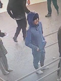 CCTV image of John Miller wearing clothing as described in text