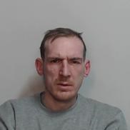 Grant Hunter, a white man with short fair hair, stubble and a grey top