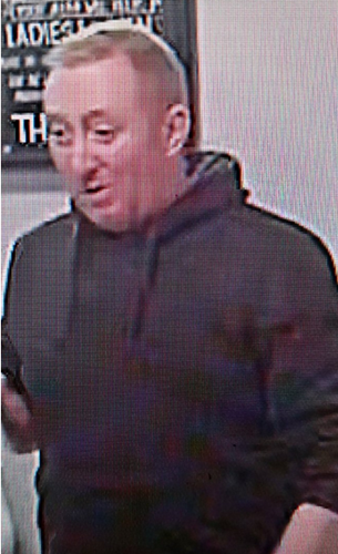 CCTV image of man with short red/blond hair. He was wearing a black hooded top and dark-coloured jeans.