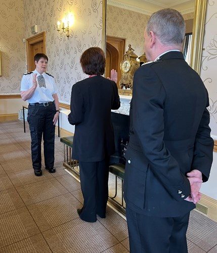 Deputy Chief Connors taking her oath of office with Justice of the Peach and Chief Constable