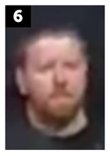 White man of medium build with short, brown hair and a short beard. He was wearing a dark-coloured sweatshirt with a white circle logo on the left chest area