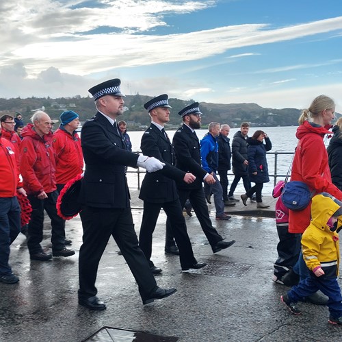 Police Scotland colleagues join with the community at a remembrance parade.