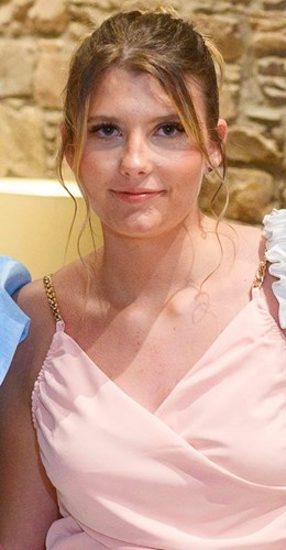 Shows Jo Marshall, a white 17-year-old female with blond hair and wearing a pink dress