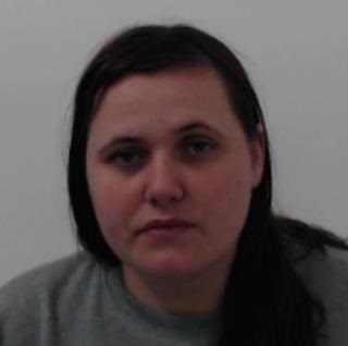 Shows custody image of Kellyanne McNaughton, a white female with dark shoulder length hair
