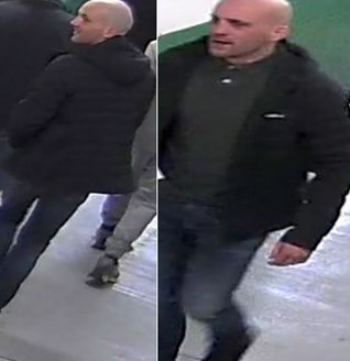 white man in his 30s, medium build, wearing black jacket, dark green polo shirt, blue jeans and black trainers