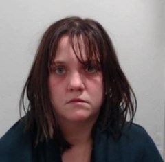 32-year-old white woman with shoulder-length brown hair and wearing a blue top