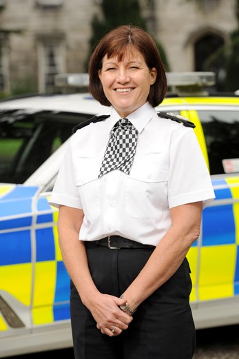 Chief Constable Jo Farrell pictured smiling in front of a police vehicle outside Police Scotland Headquarters, Tulliallan.